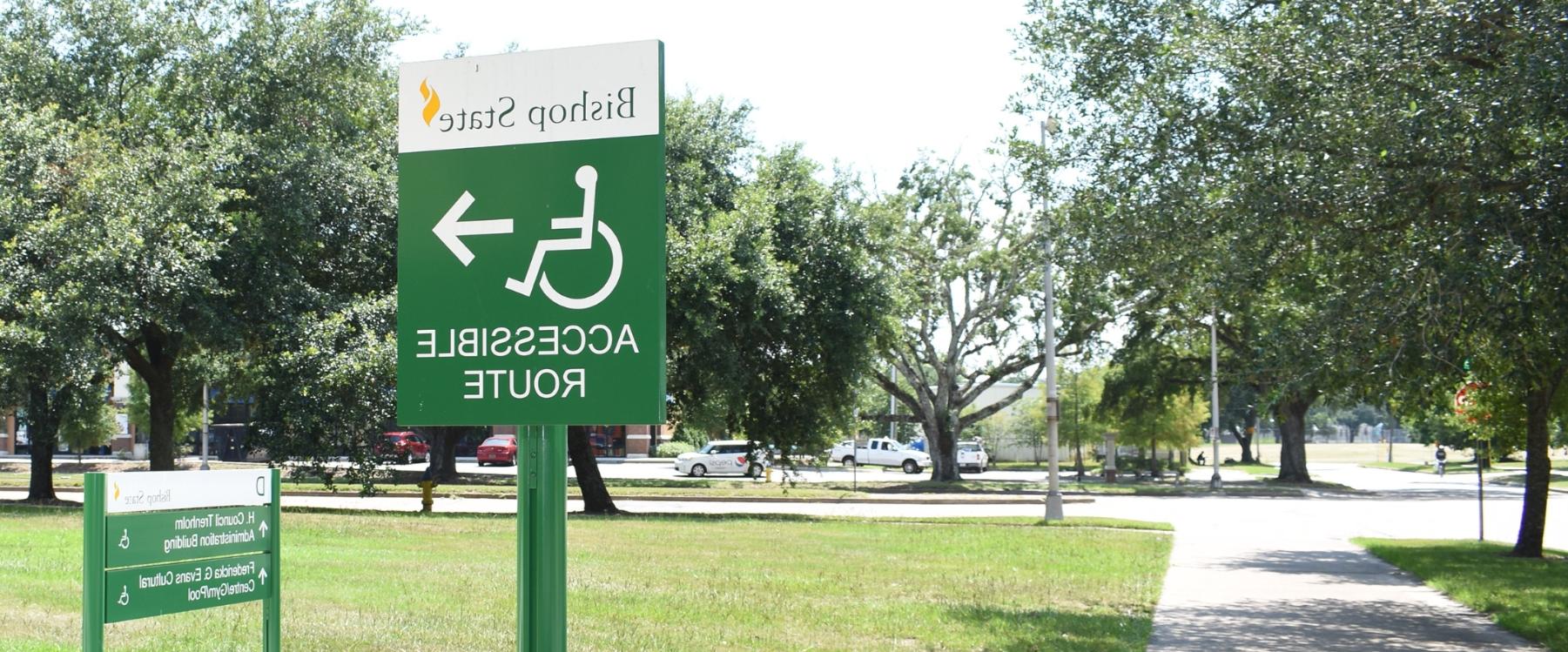 Outdoor sign with Accessible Route written